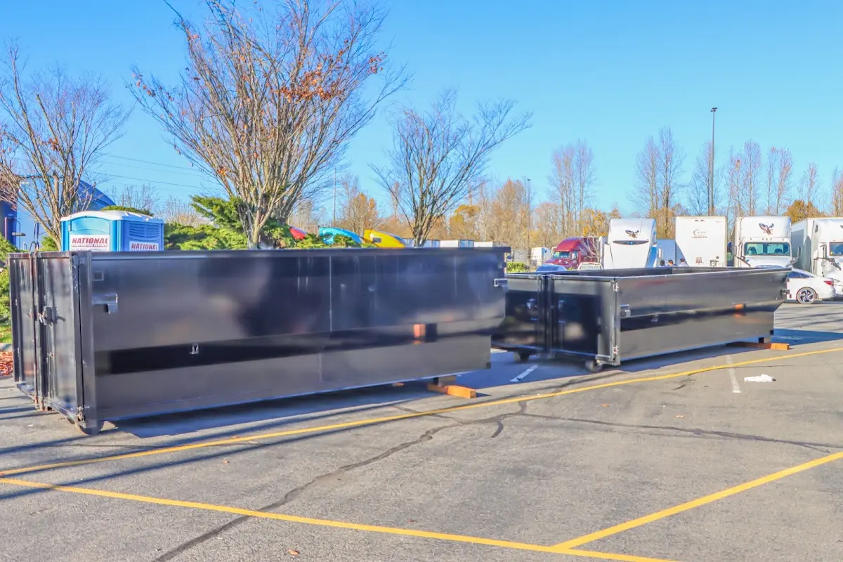 Professional dumpster rental service with roll-off container on residential driveway in Melrose Park